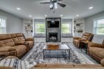Large open Living room with comfortable couches, recliners, and a gas fireplace